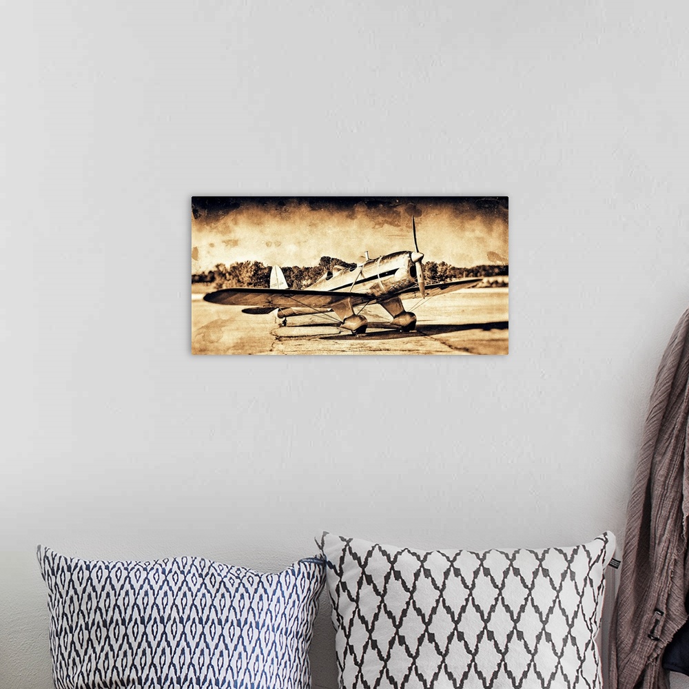A bohemian room featuring A distressed photograph of an antique airplane.