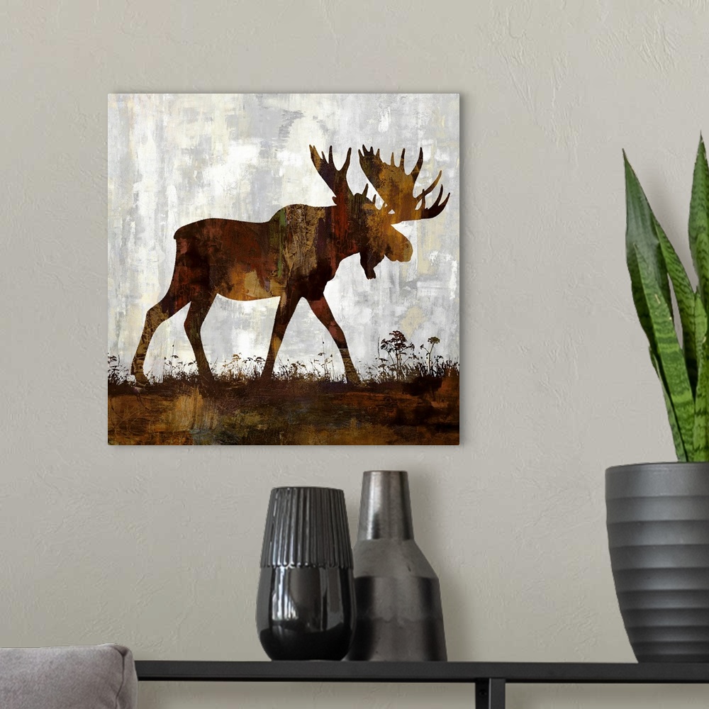 A modern room featuring Square decor with a brown and gold silhouette of a moose on a gray, tan, and white background.