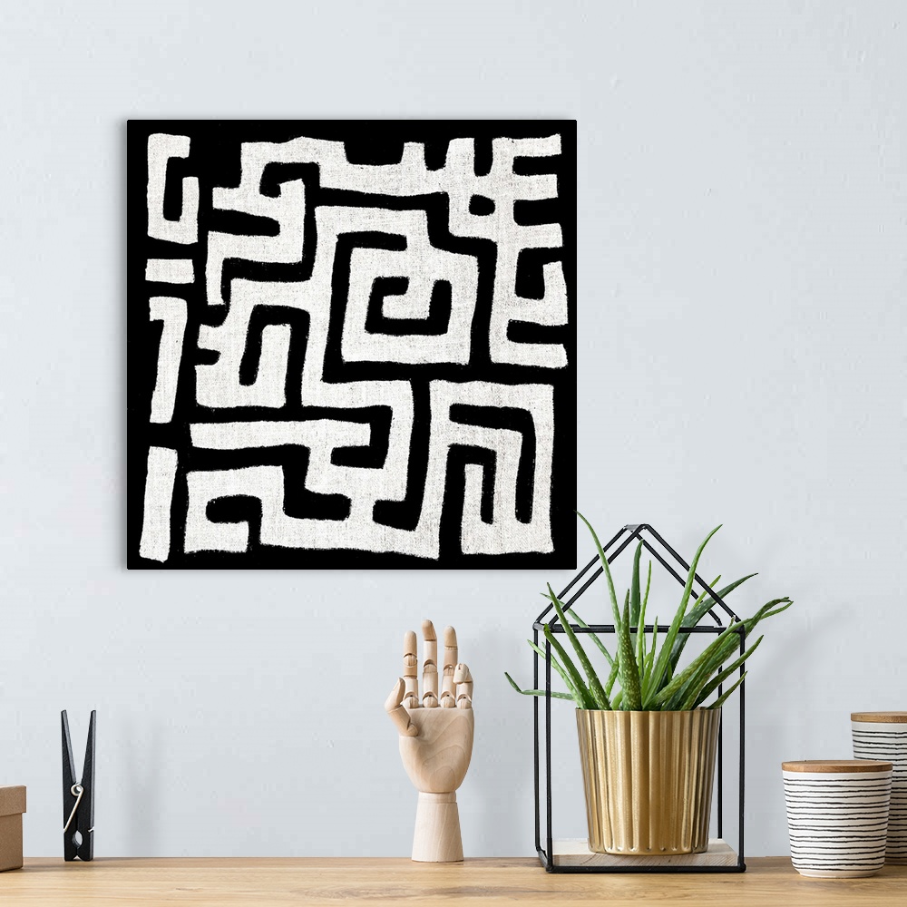 A bohemian room featuring Square abstract black and white patterned art.