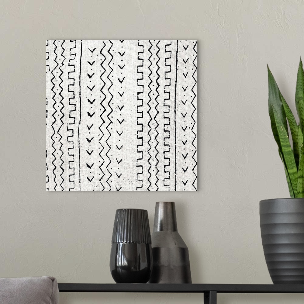 A modern room featuring Square abstract black and white patterned art created with lines and dots.