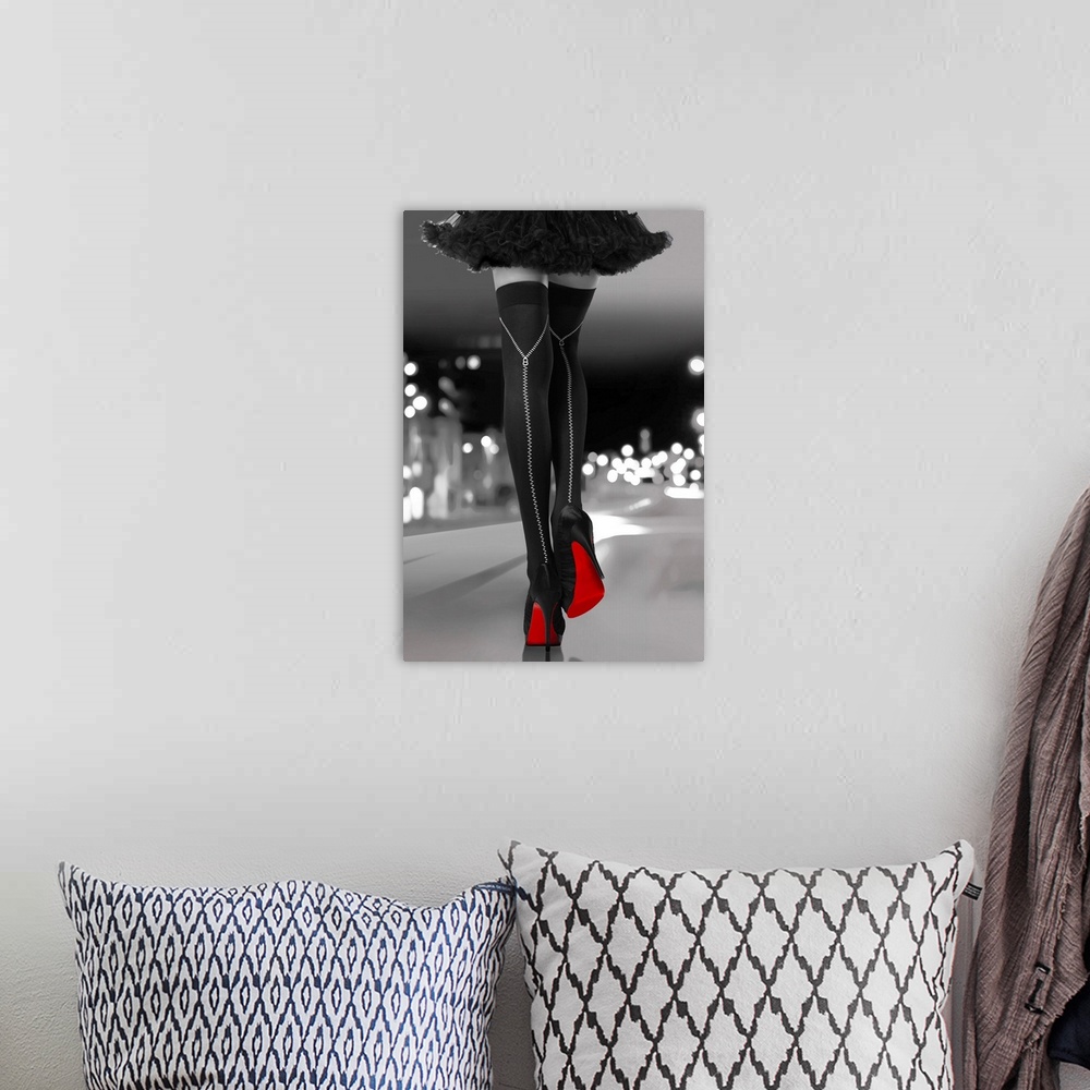 A bohemian room featuring Black and white photograph of a woman's long legs with black high heels and bright red soles walk...