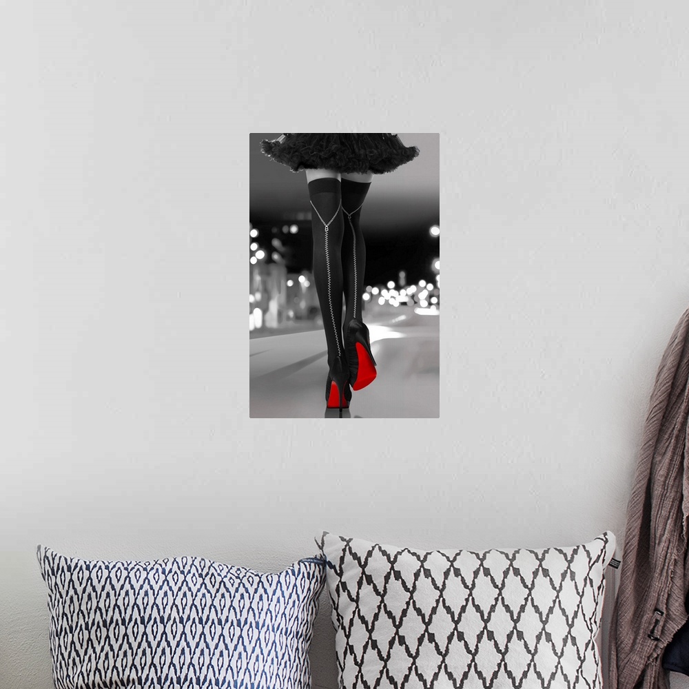 A bohemian room featuring Black and white photograph of a woman's long legs with black high heels and bright red soles walk...
