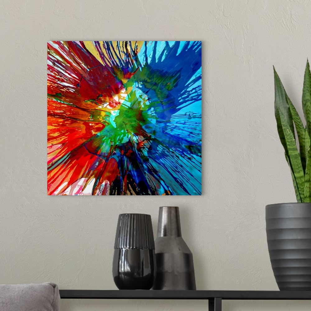 A modern room featuring Square abstract painting with a tie-dye effect in shades of blue, green, red, and yellow.