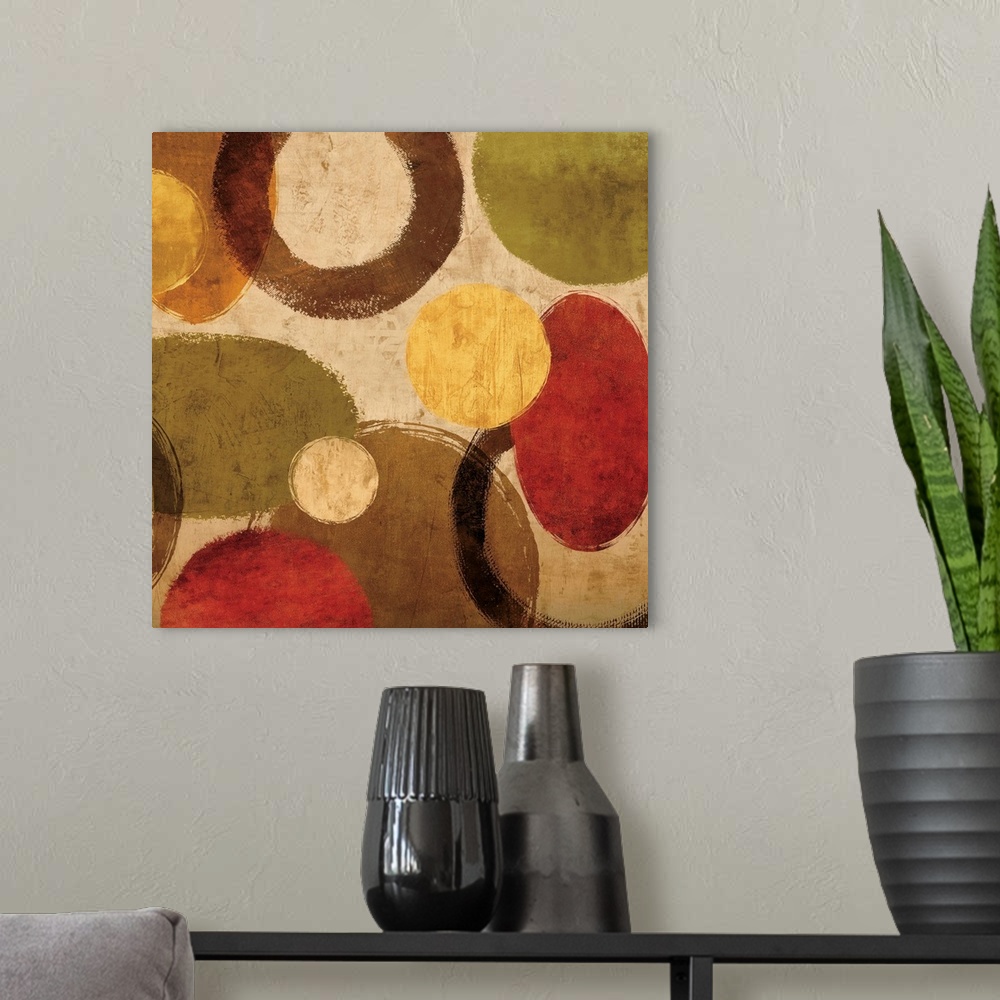 A modern room featuring Square abstract art created with red, green, gold, and brown circular shapes on a neutral colored...