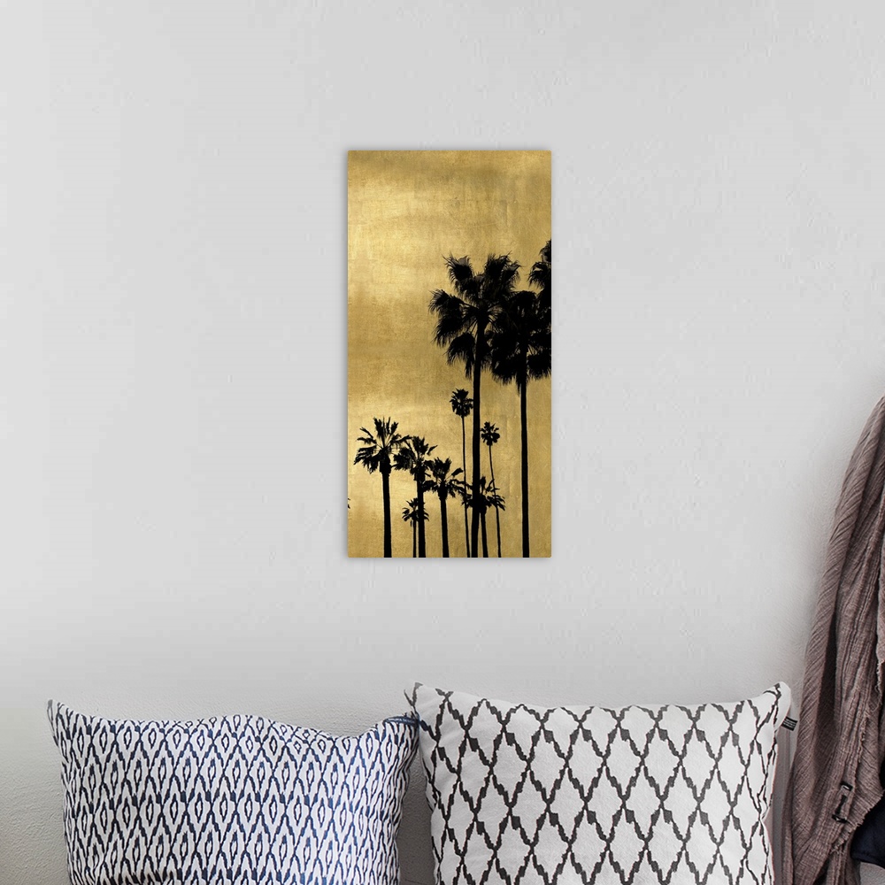 A bohemian room featuring Decorative artwork featuring a black silhouette of a palm tree over a distressed background.
