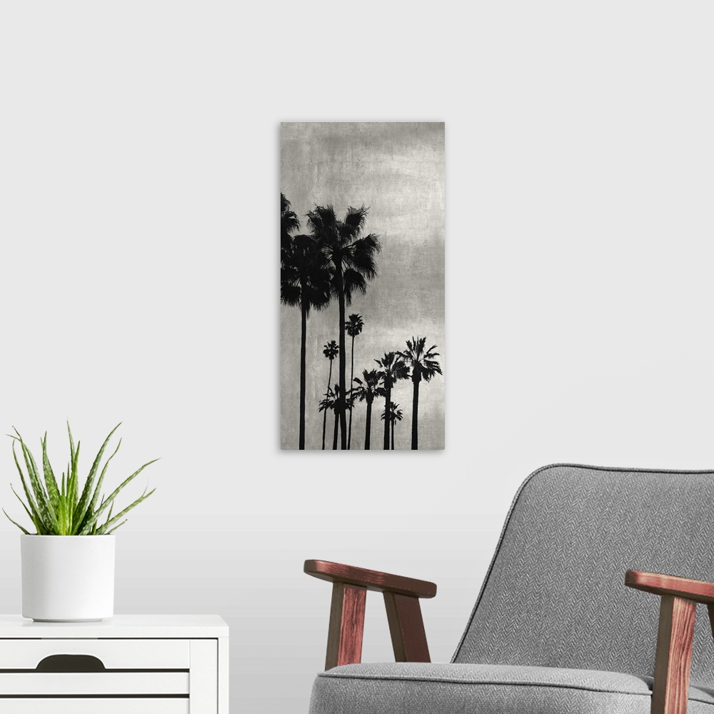 A modern room featuring Decorative artwork featuring a black silhouette of a palm tree over a distressed background.