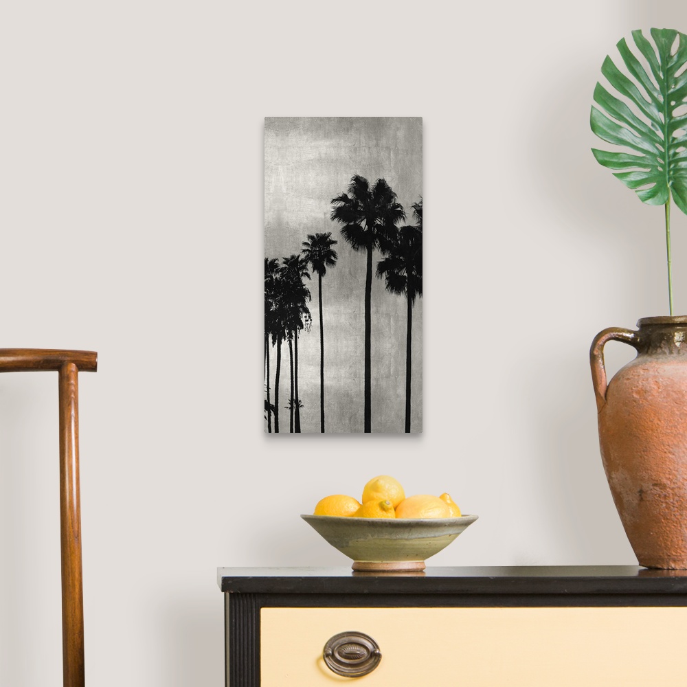 A traditional room featuring Decorative artwork featuring a black silhouette of a palm tree over a distressed background.