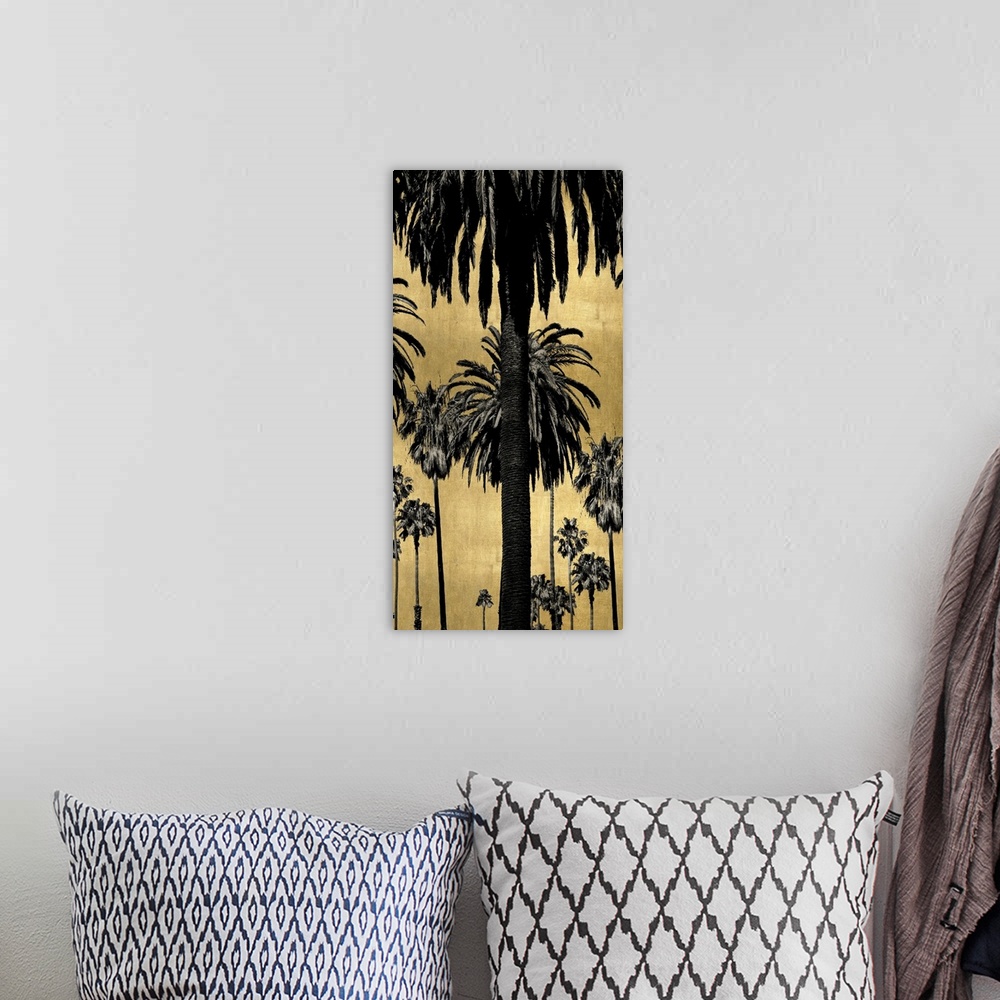 A bohemian room featuring Decorative artwork featuring a black silhouette of palm trees over a distressed background.
