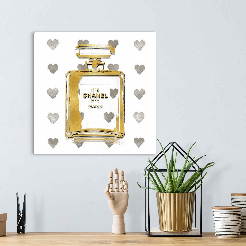 A bohemian room featuring A white background with hearts peek through a transparent bottle of perfume.
