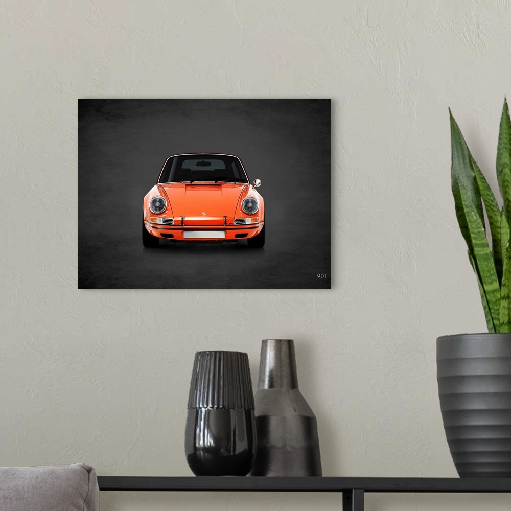 A modern room featuring Photograph of an orange Porsche 901 printed on a black background with a dark vignette.