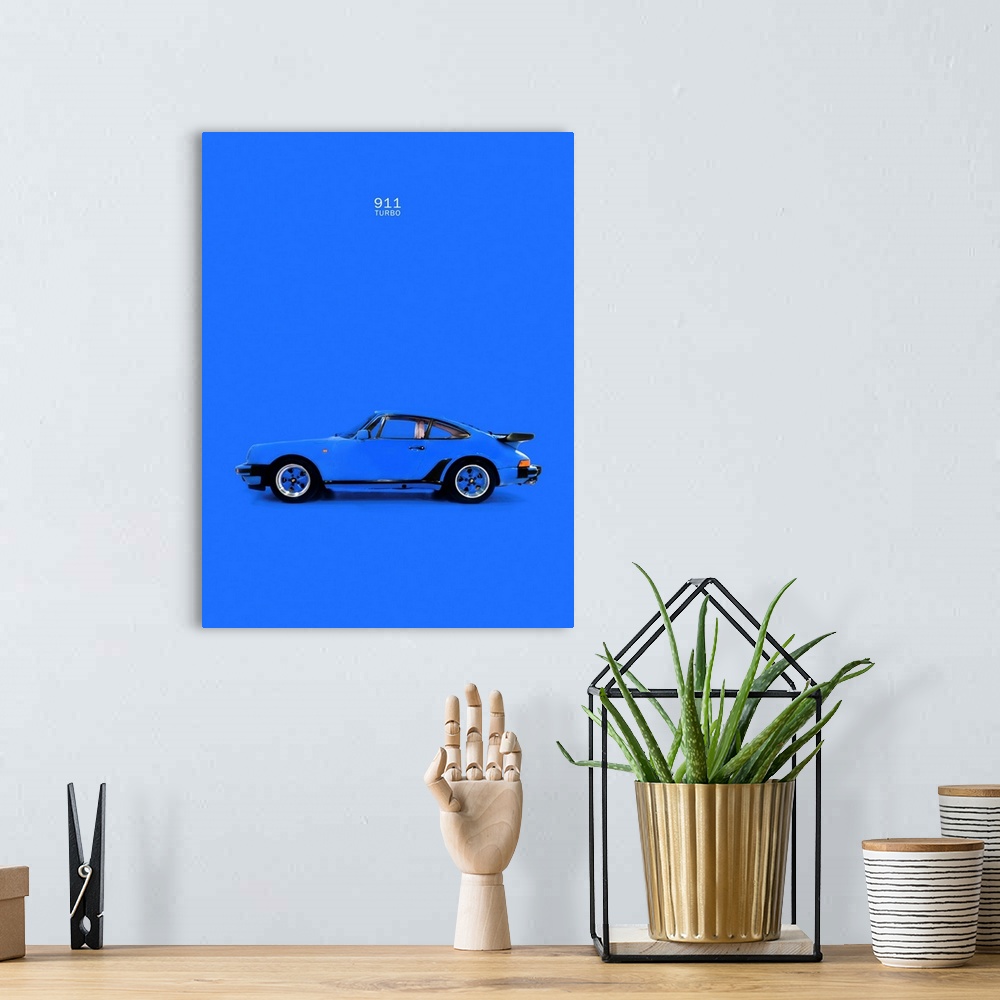 A bohemian room featuring Photograph of a blue Porsche 911 Turbo printed on a blue background