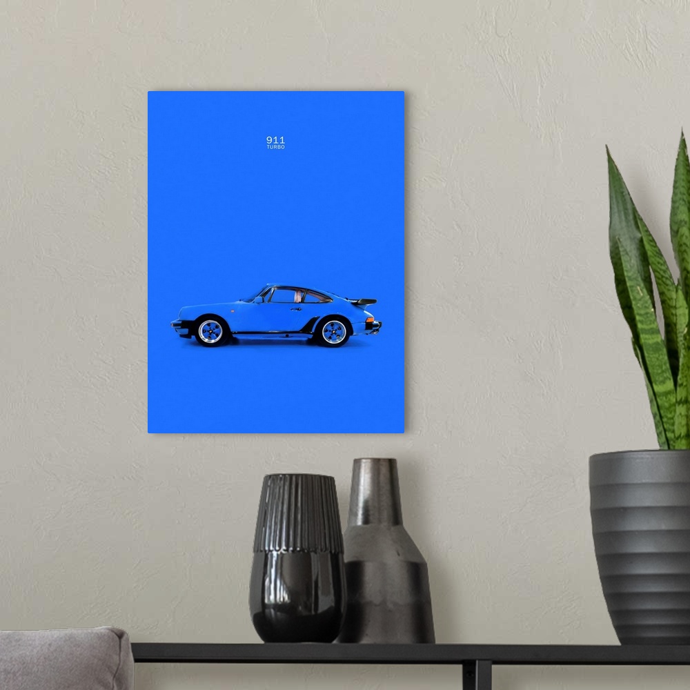 A modern room featuring Photograph of a blue Porsche 911 Turbo printed on a blue background