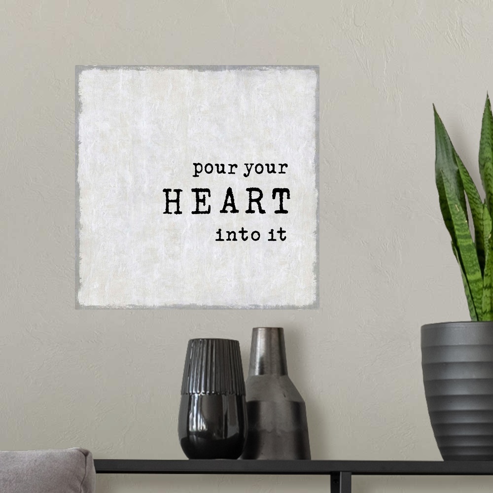 A modern room featuring "Pour Your Heart Out" on a square background in shades of gray.