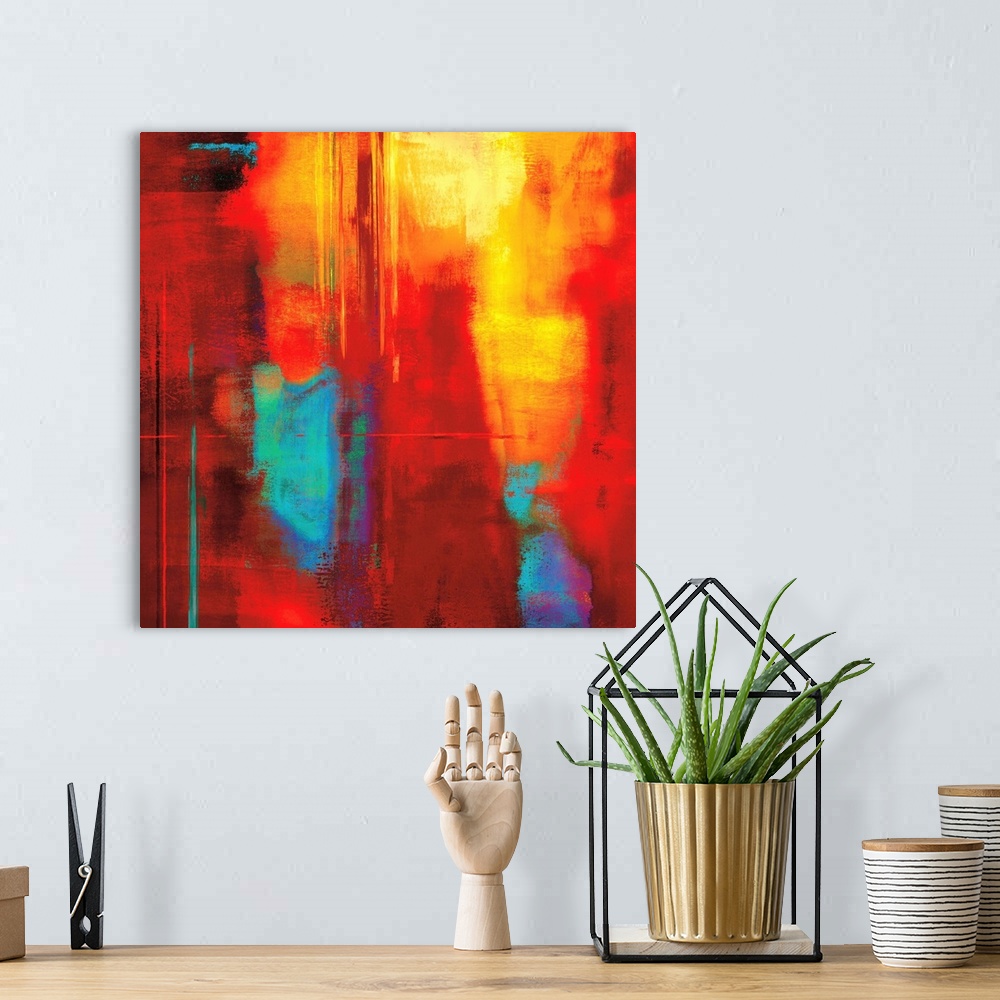 A bohemian room featuring Bright red square abstract art with cool hints of blue, green, and purple.