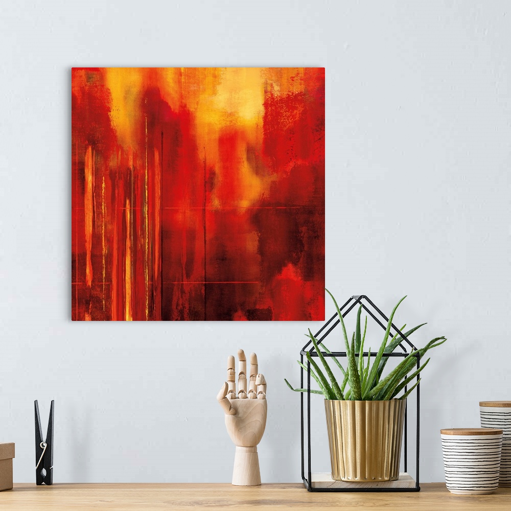 A bohemian room featuring Bright red square abstract art with yellow mixed in and thin lined designs on the side.