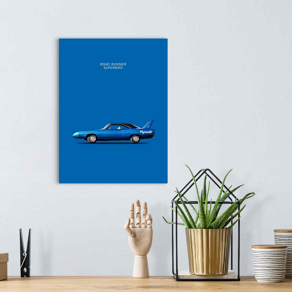 A bohemian room featuring Photograph of a blue Road-Runner Superbird 1970 printed on a blue background