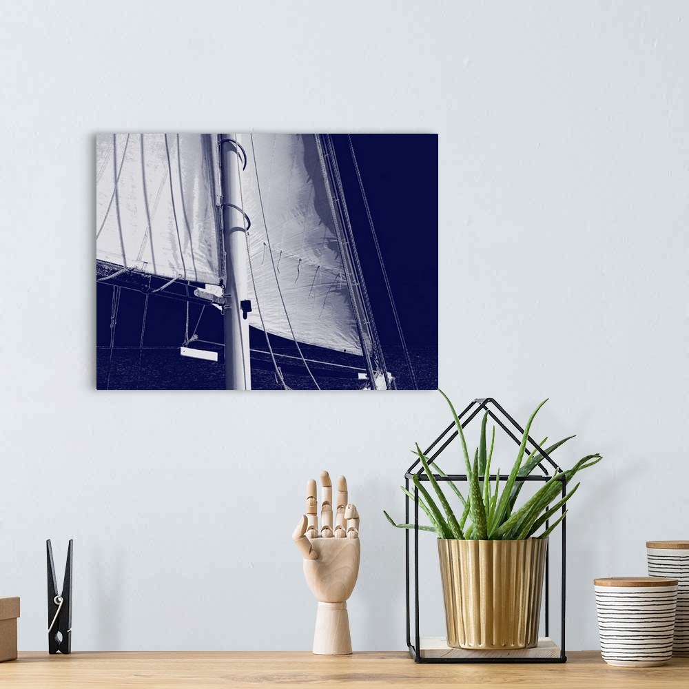 A bohemian room featuring Indigo and white illustration of a sail from a sailboat.