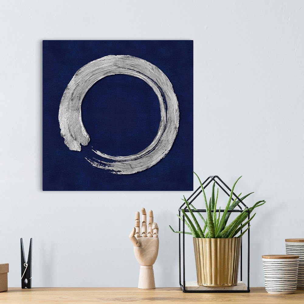 A bohemian room featuring This Zen artwork features a sweeping circular brush stroke in silver over a mottled blue background.