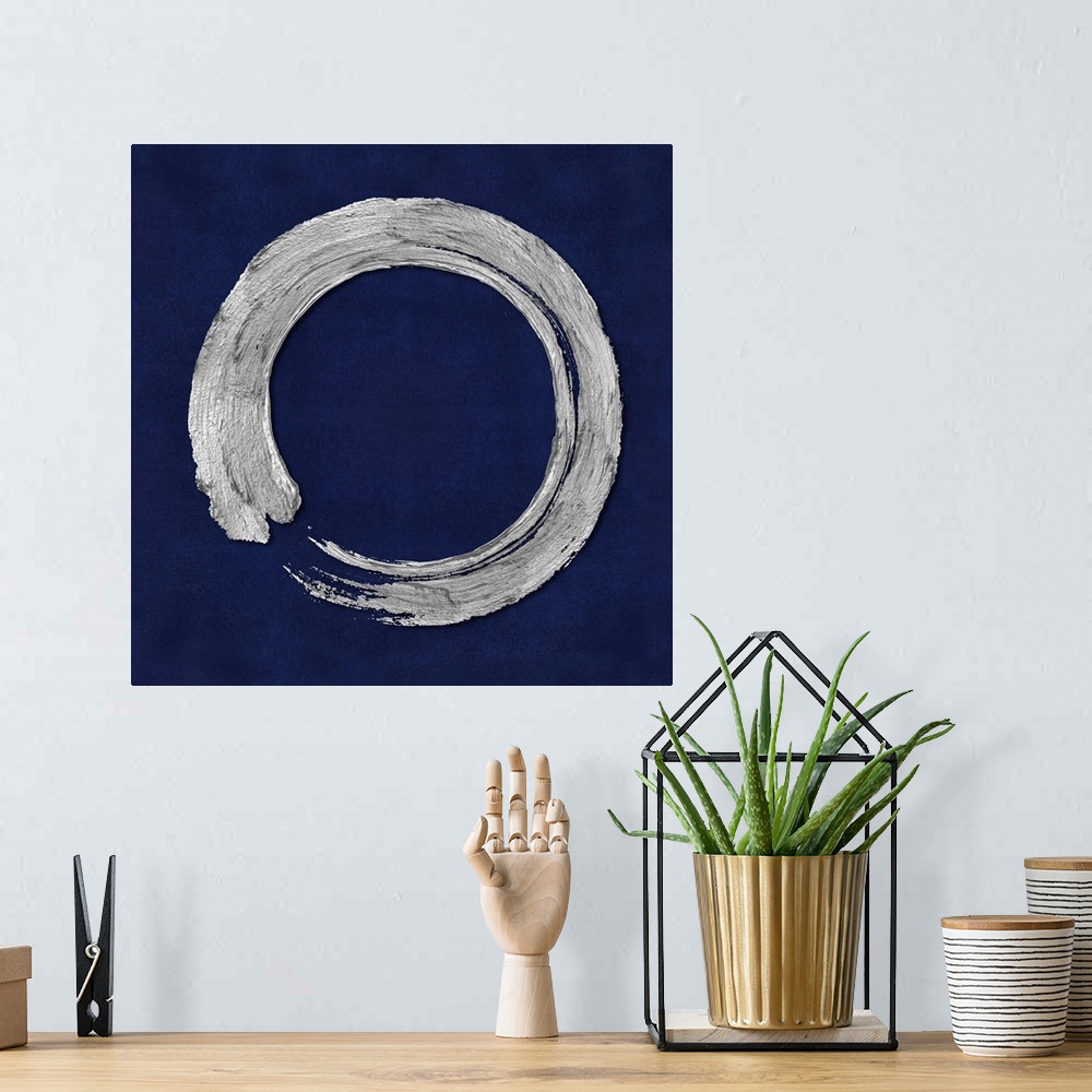 A bohemian room featuring This Zen artwork features a sweeping circular brush stroke in silver over a mottled blue background.