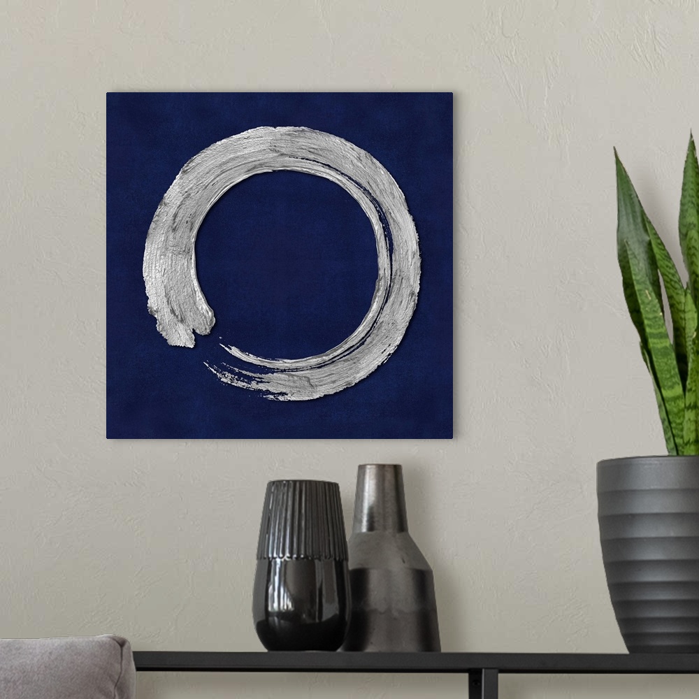 A modern room featuring This Zen artwork features a sweeping circular brush stroke in silver over a mottled blue background.