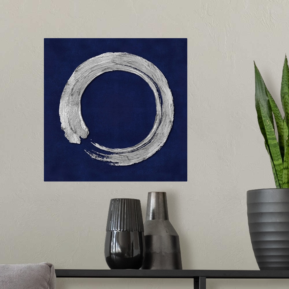 A modern room featuring This Zen artwork features a sweeping circular brush stroke in silver over a mottled blue background.