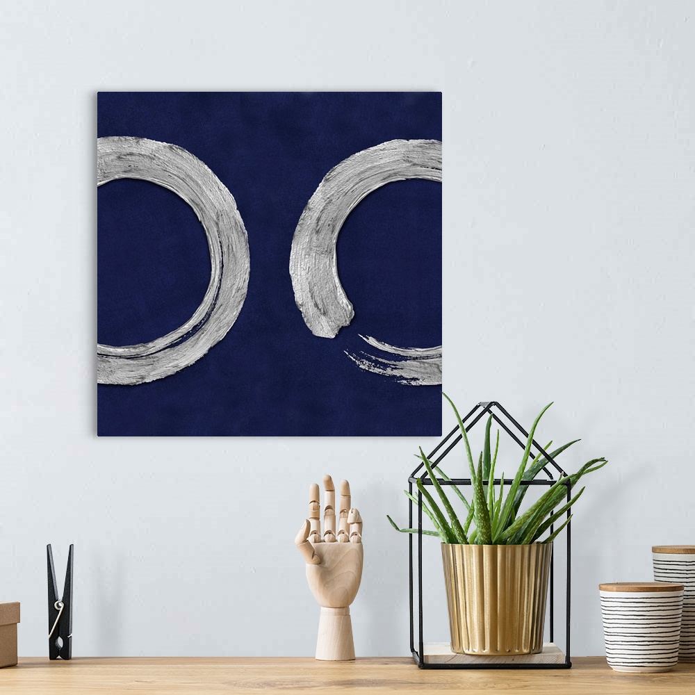 A bohemian room featuring This Zen artwork features two sweeping circular brush strokes in silver over a mottled blue backg...