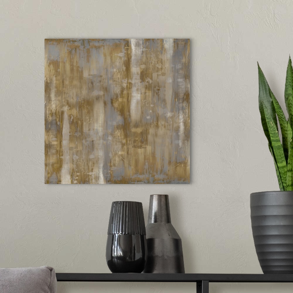 A modern room featuring Square abstract painting with shades of metallic gold and silver streaking down the canvas.