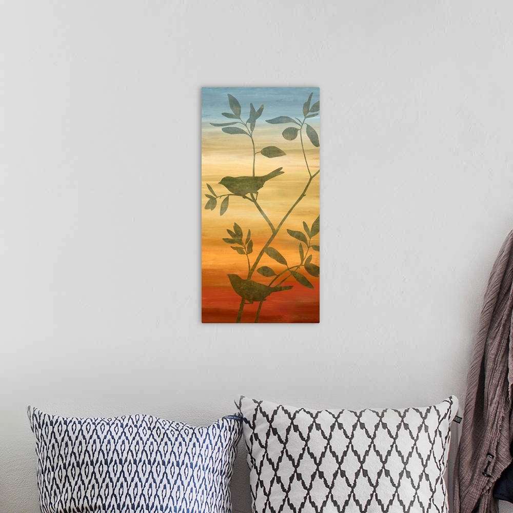 A bohemian room featuring Silhouettes of birds on branches with leaves on a blue, yellow, orange, and red gradient background.