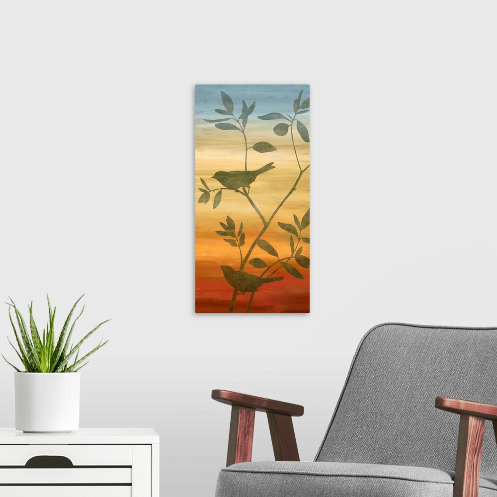 A modern room featuring Silhouettes of birds on branches with leaves on a blue, yellow, orange, and red gradient background.