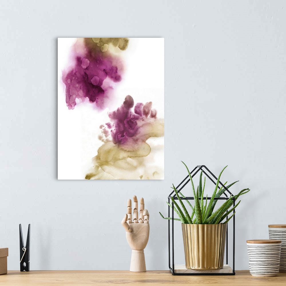 A bohemian room featuring Abstract painting with fuchsia and gold hues splattered together on a white background.