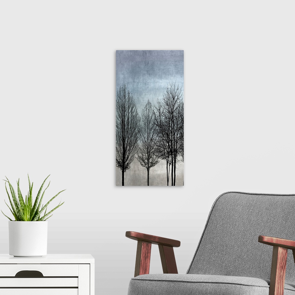 A modern room featuring Decorative artwork featuring a black silhouette of leafless trees over a distressed background.
