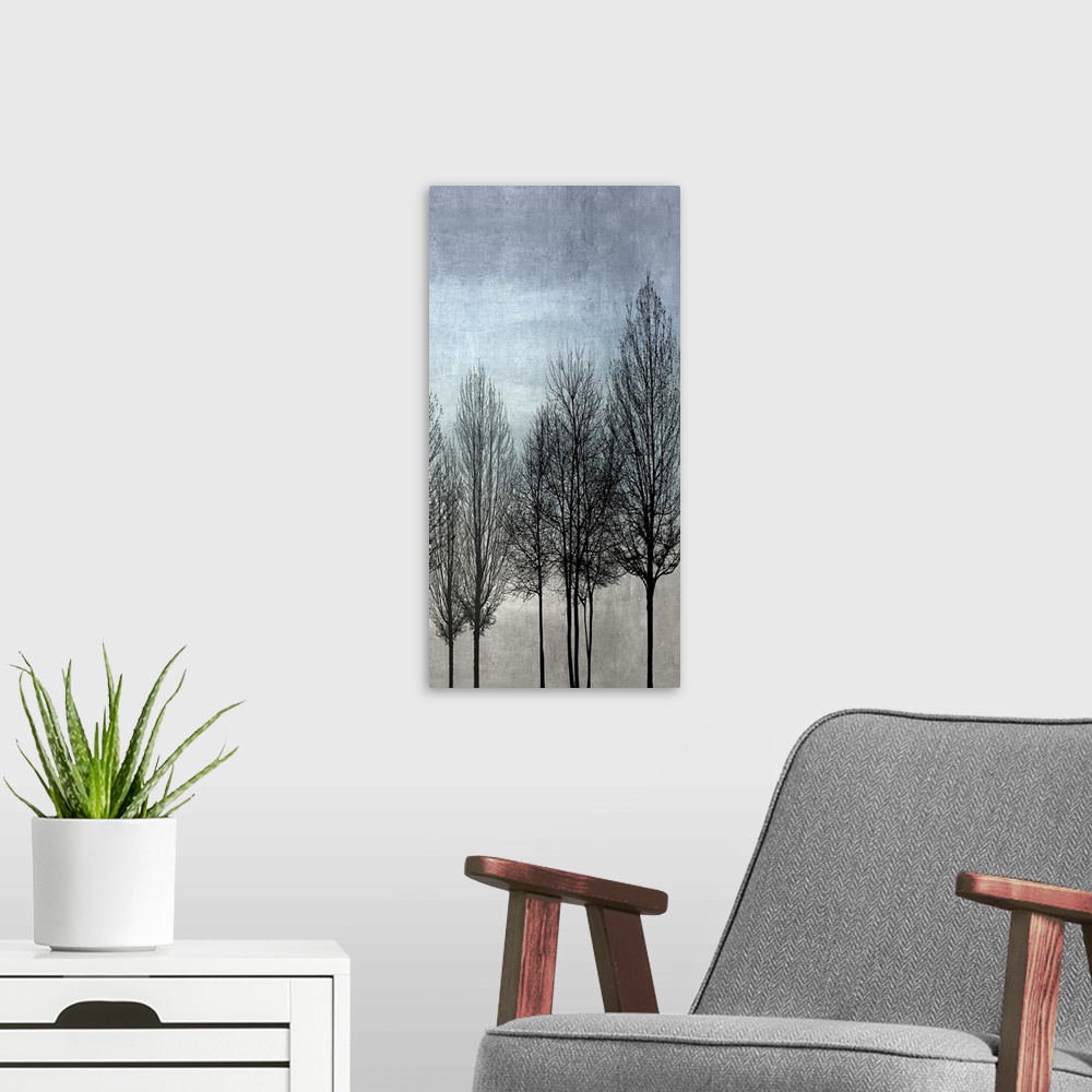 A modern room featuring Decorative artwork featuring a black silhouette of leafless trees over a distressed background.