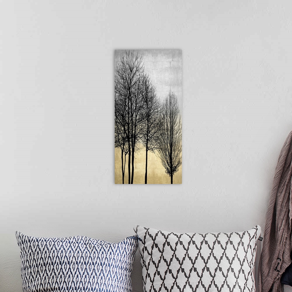 A bohemian room featuring Decorative artwork featuring a black silhouette of leafless trees over a distressed background.