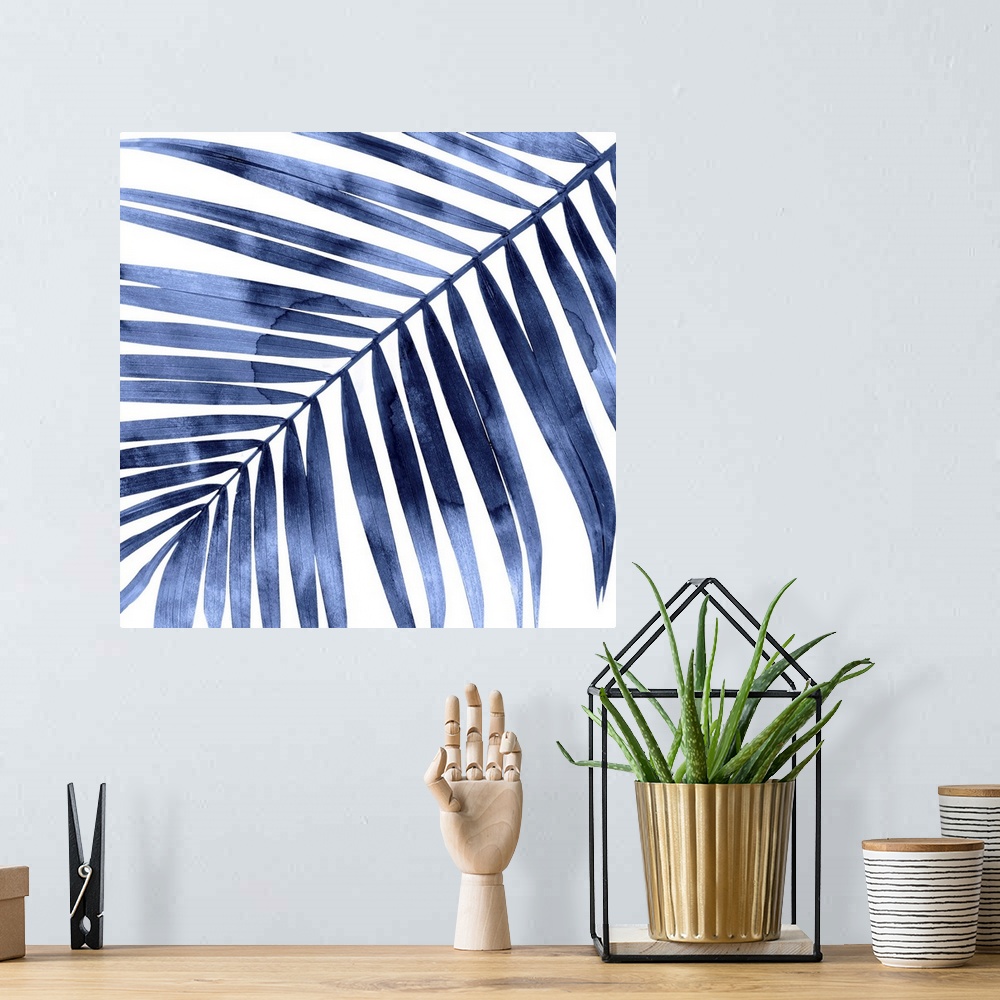 A bohemian room featuring Square decor with an indigo silhouette of a palm leaf on a solid white background.