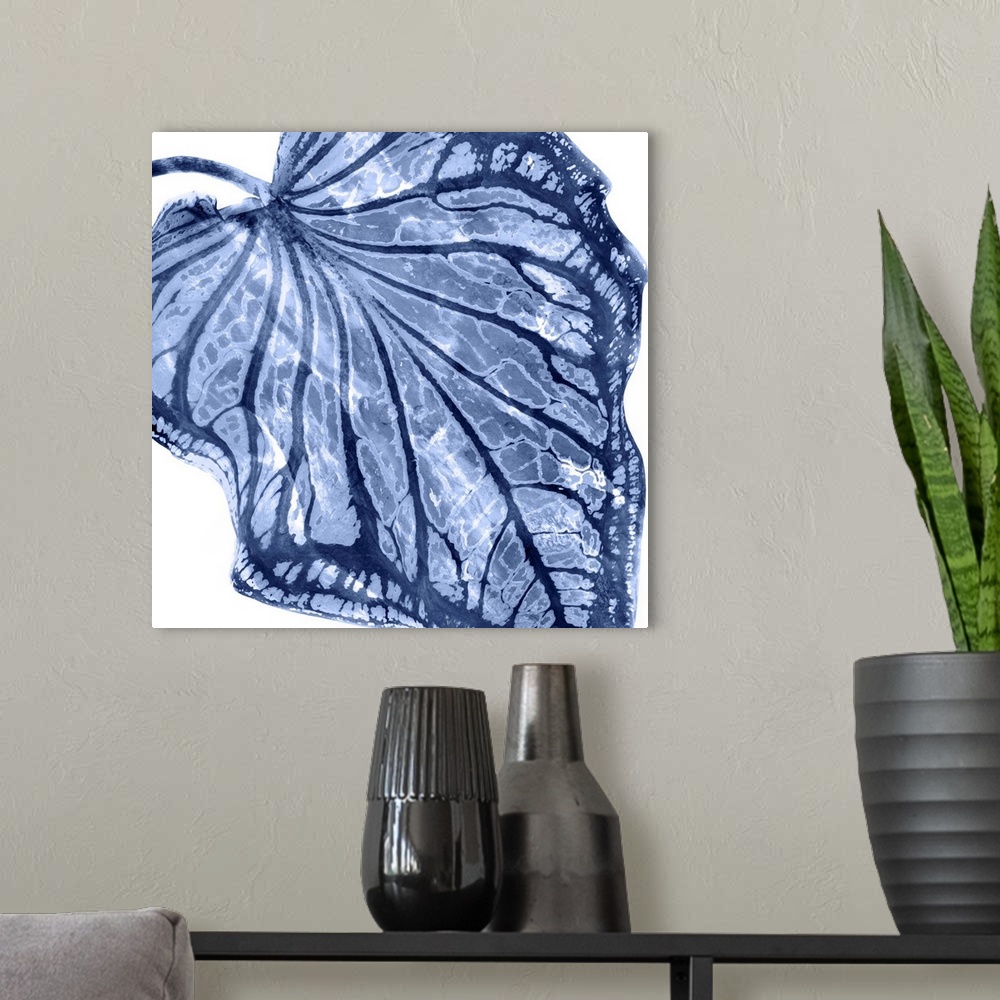 A modern room featuring Square decor with an indigo silhouette of a palm leaf on a solid white background.
