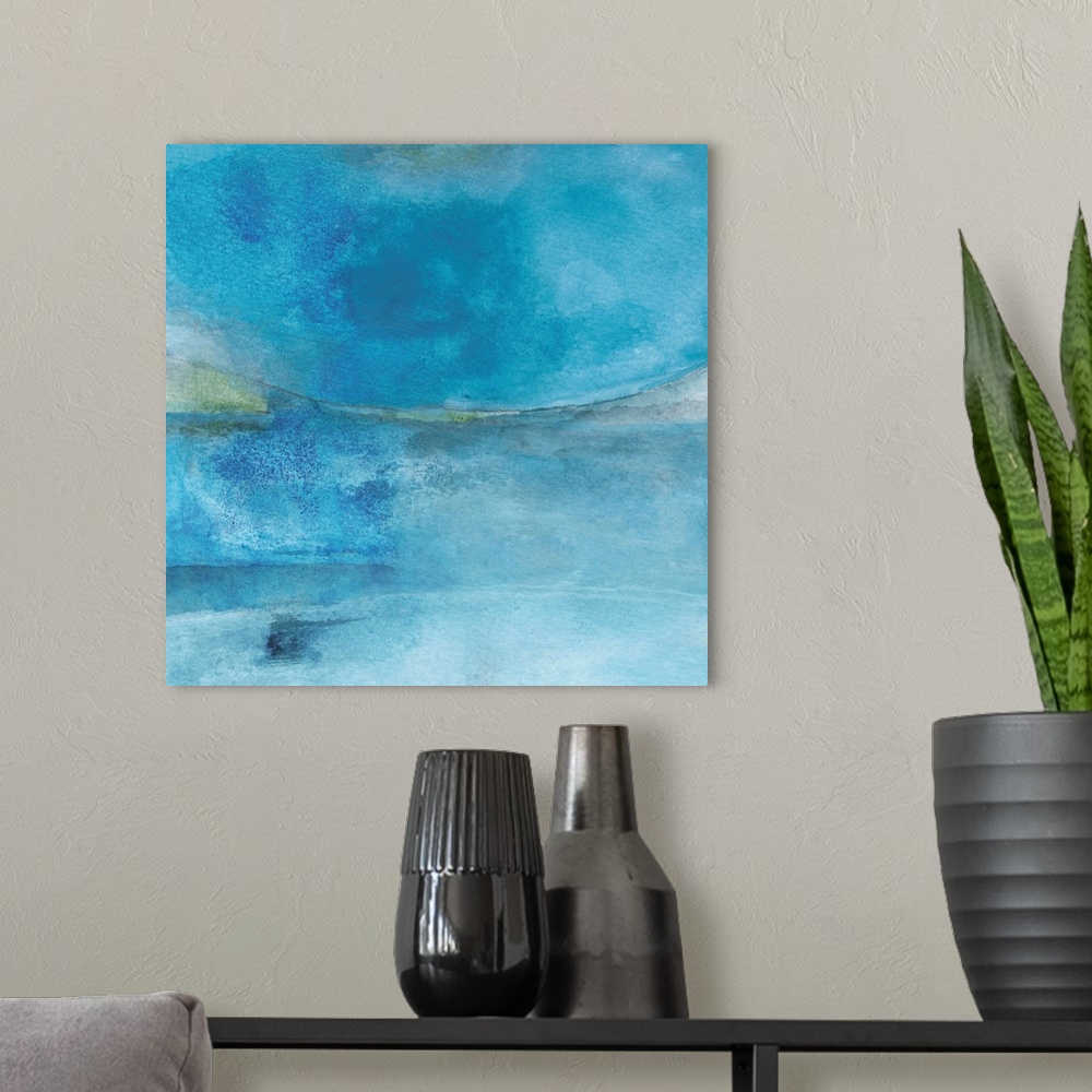 A modern room featuring Square abstract painting created with shades of blue coming together.