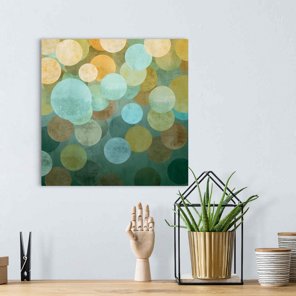 A bohemian room featuring Square abstract art created with circles in yellow, blue, and green hues overlapping together on ...