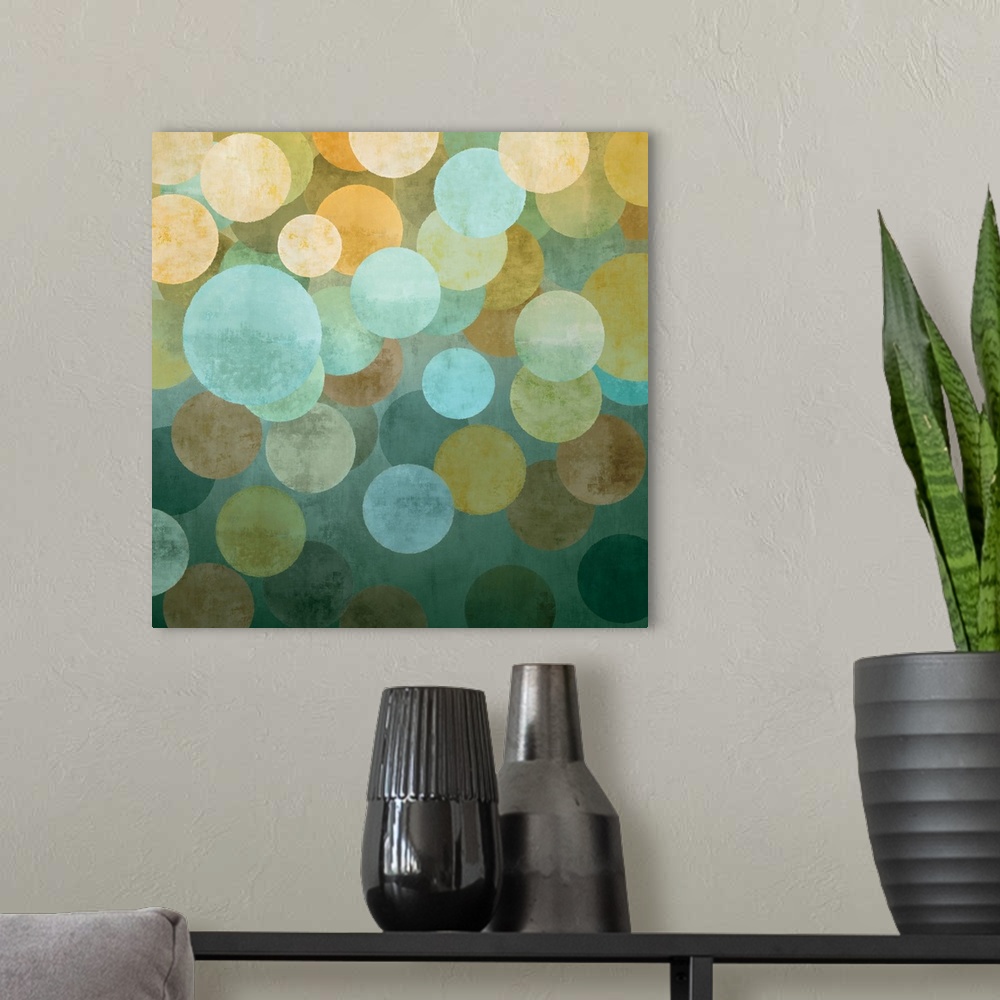 A modern room featuring Square abstract art created with circles in yellow, blue, and green hues overlapping together on ...
