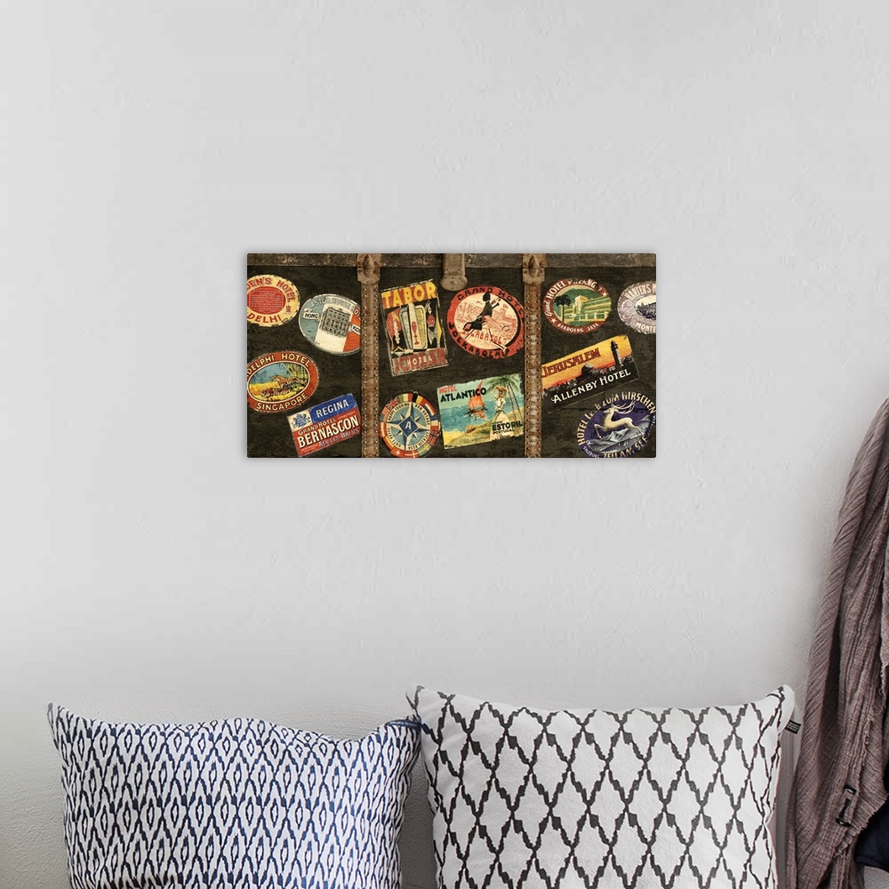 A bohemian room featuring Decor with an image of a wooden trunk covered in travel stickers.