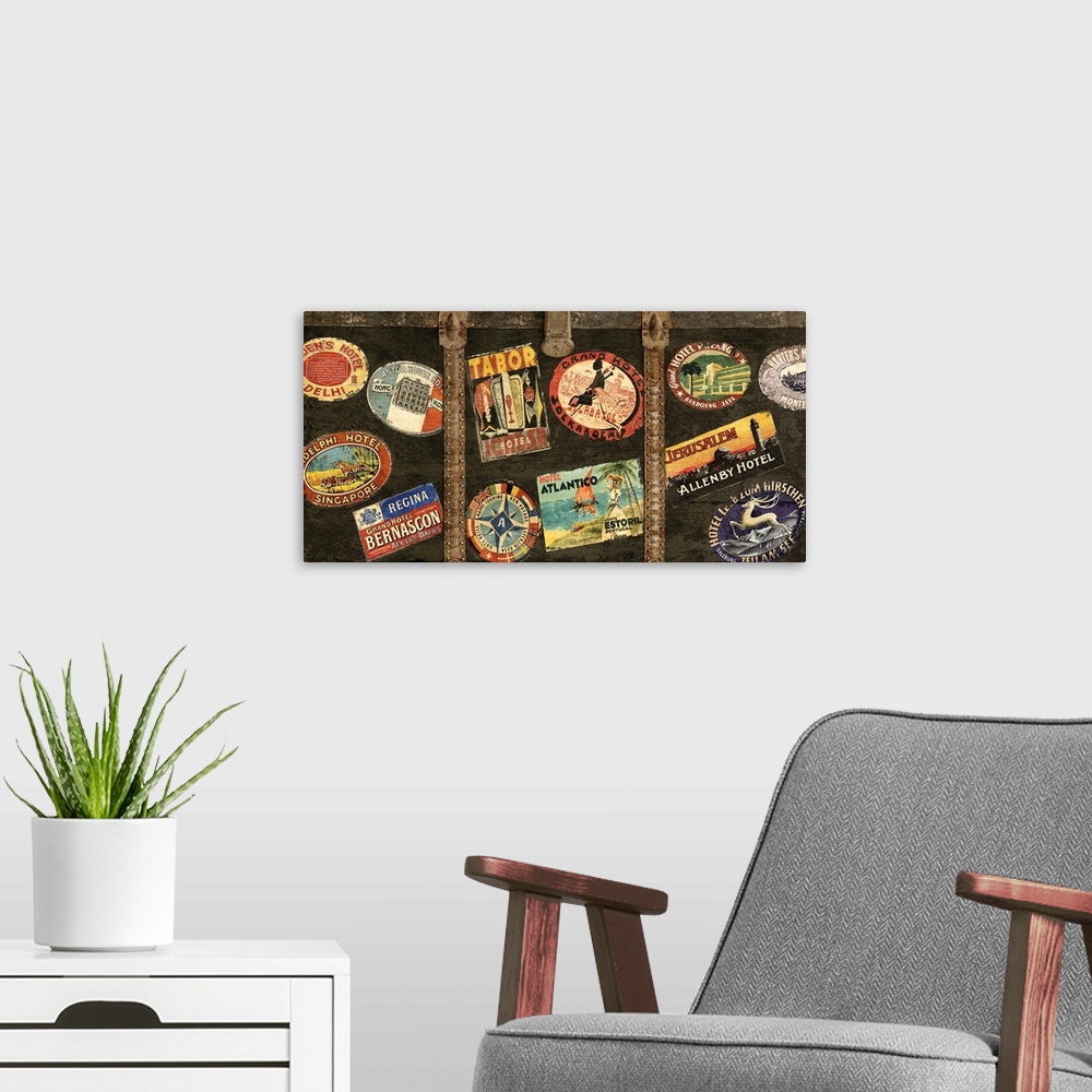 A modern room featuring Decor with an image of a wooden trunk covered in travel stickers.