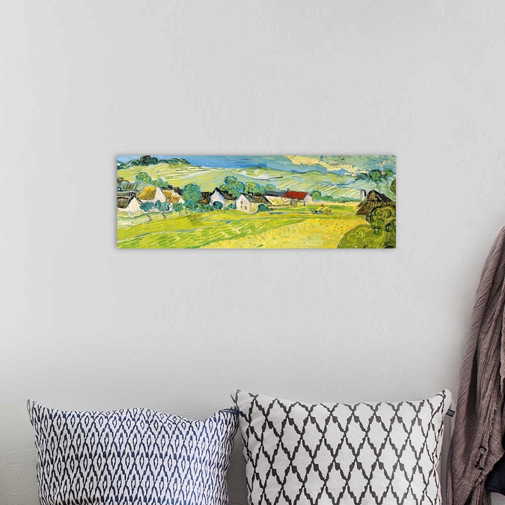A bohemian room featuring Painting of a beautiful landscape of a village and fields by Vincent Van Gogh.