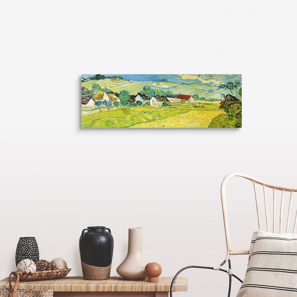 A farmhouse room featuring Painting of a beautiful landscape of a village and fields by Vincent Van Gogh.
