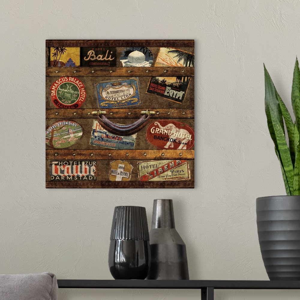 A modern room featuring Square decor with an image of a wooden trunk covered in travel stickers.