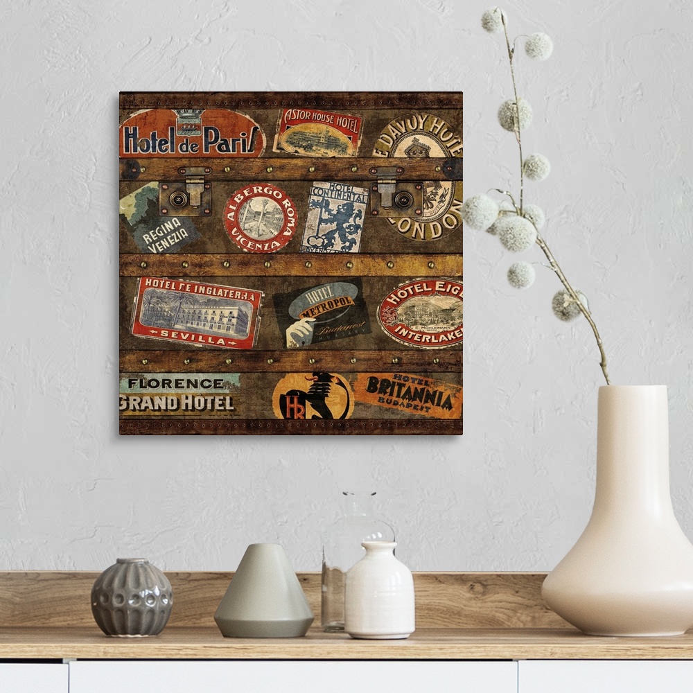 A farmhouse room featuring Square decor with an image of a wooden trunk covered in travel stickers.