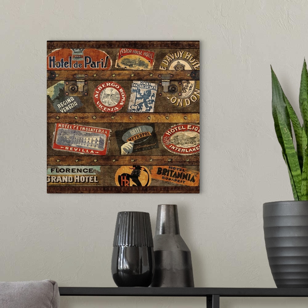 A modern room featuring Square decor with an image of a wooden trunk covered in travel stickers.