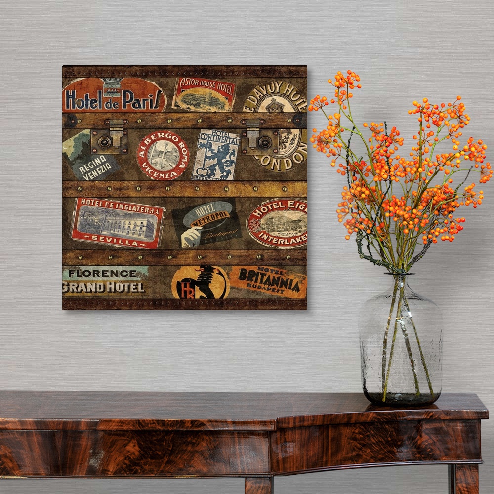 A traditional room featuring Square decor with an image of a wooden trunk covered in travel stickers.