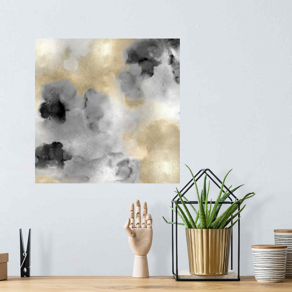 A bohemian room featuring Abstract painting with gold and black hues splattered together on a silver background.