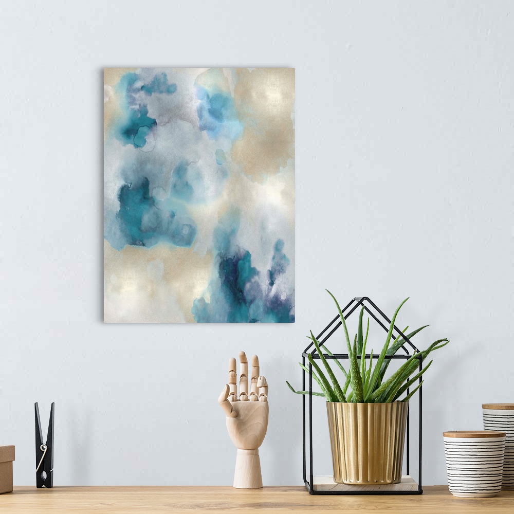 A bohemian room featuring Abstract painting with shades of blue and gold hues splattered together on a silver background.