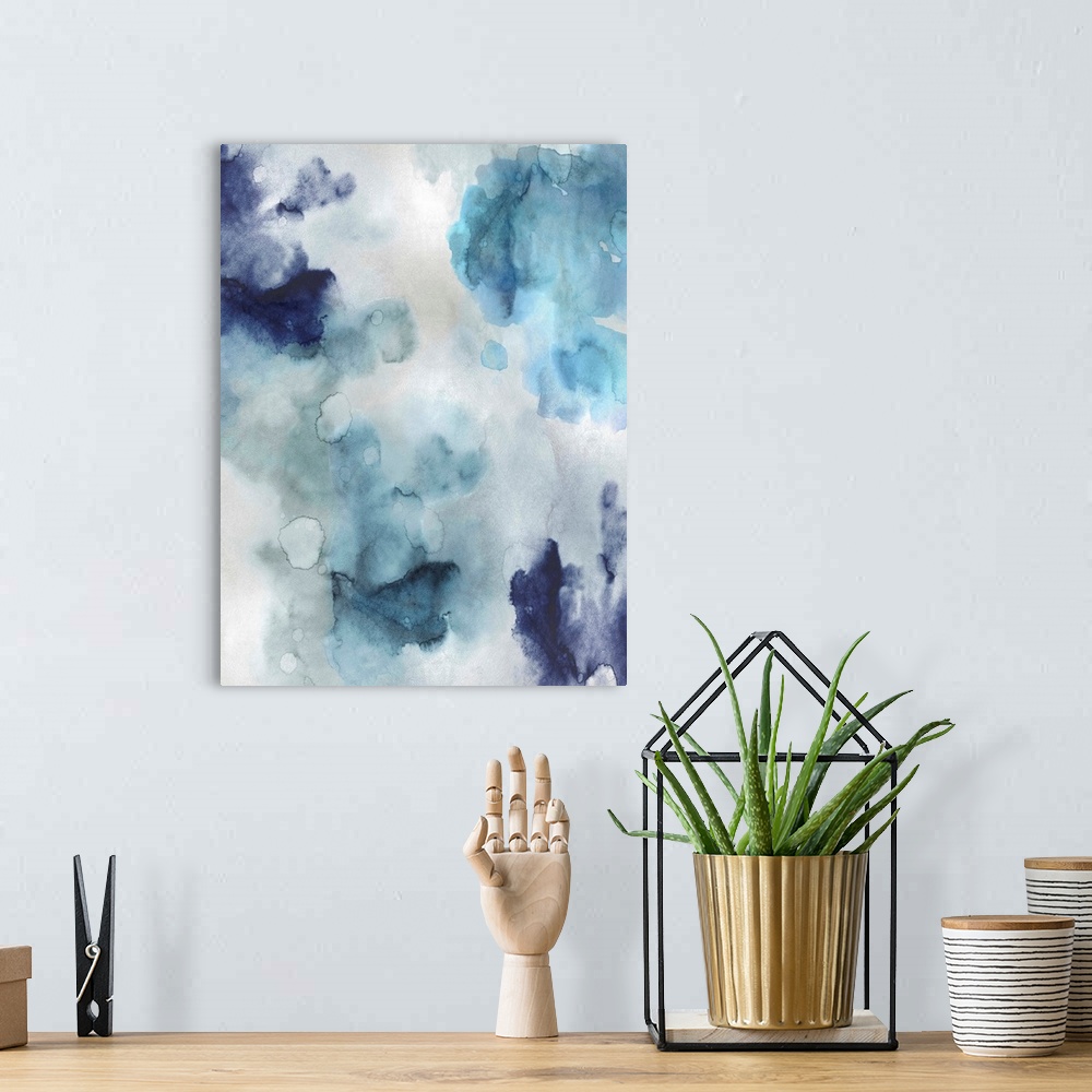 A bohemian room featuring Abstract painting with shades of blue hues splattered together on a silver background.