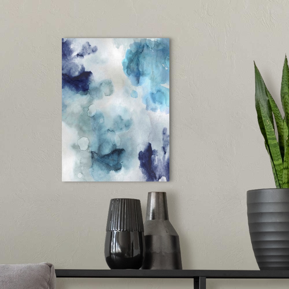 A modern room featuring Abstract painting with shades of blue hues splattered together on a silver background.